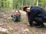 Paula and research specialist Melissa Fadden showing off their newest friend: a tiny juvenile red-spotted newt! He's hiding next to a clump of moss between the two scientists.