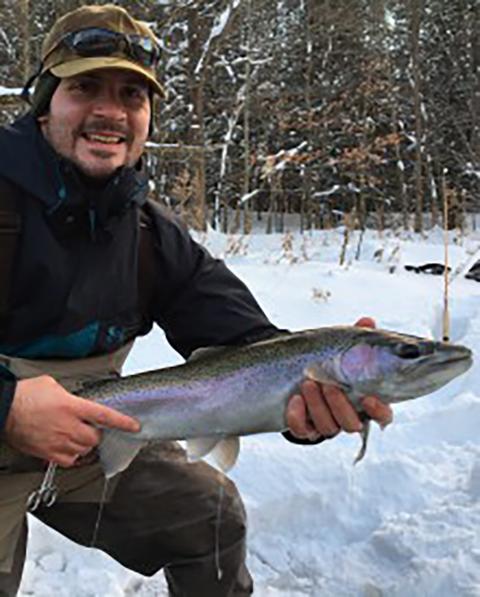 Gavin ice fishing and showing off his catch