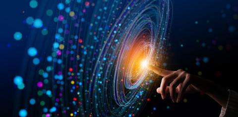 Blue swirling light on screen with finger at center