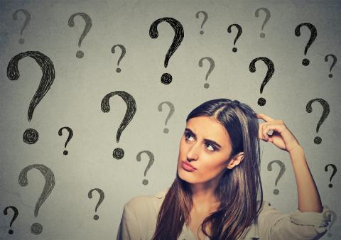 women with questions marks as a background
